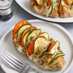 Hasselback chicken on a plate with a fork