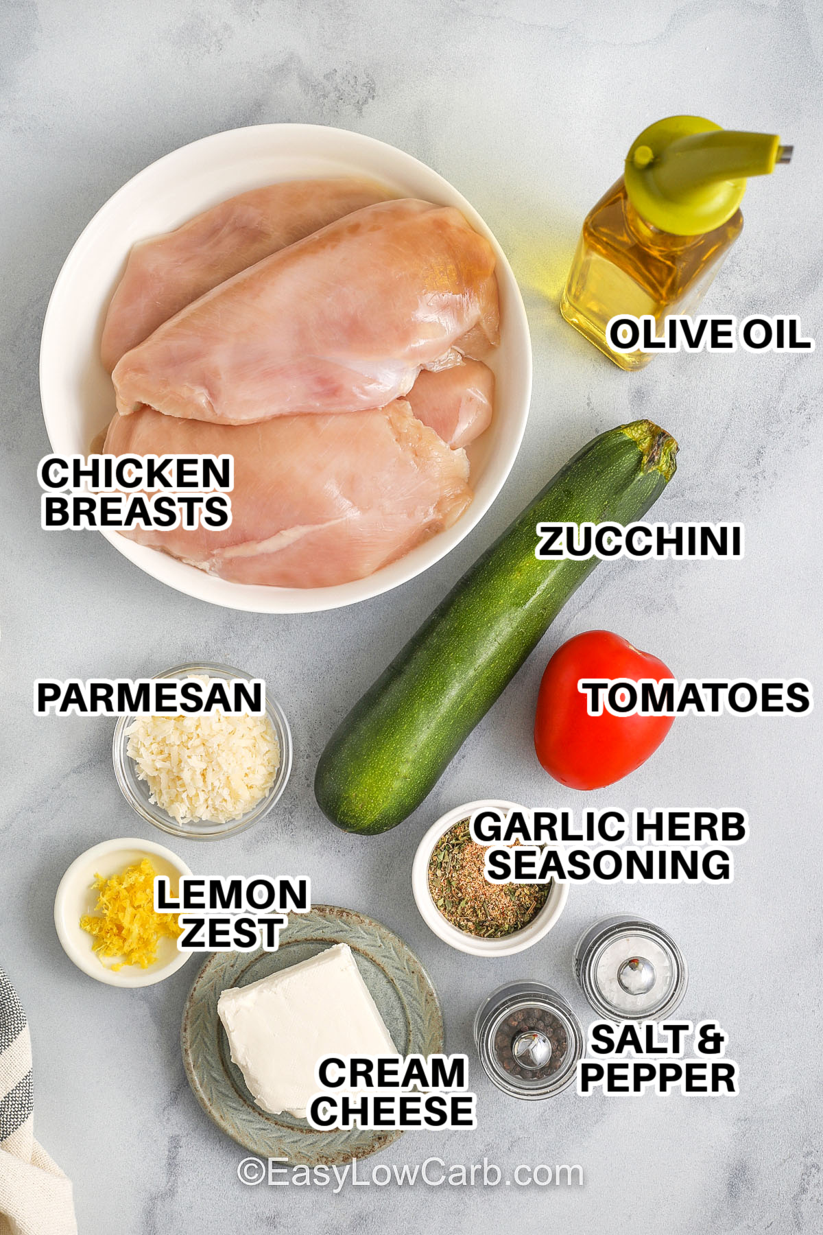 This easy Hasselback chicken recipe makes a juicy, oven baked dinner that’s both healthy and delicious. Each chicken breast is stuffed with a creamy cheese blend, zucchini, and tomato for a flavorful low carb meal everyone will love. It’s loaded with protein and baked to golden perfection. Great for busy weeknights or as a lighter option for a holiday gathering. #easylowcarb Hasselback chicken ingredients labeled: olive oil, chicken breasts, zucchini, tomatoes, parmesan, lemon zest, garlic herb seasoning, salt & pepper, cream cheese