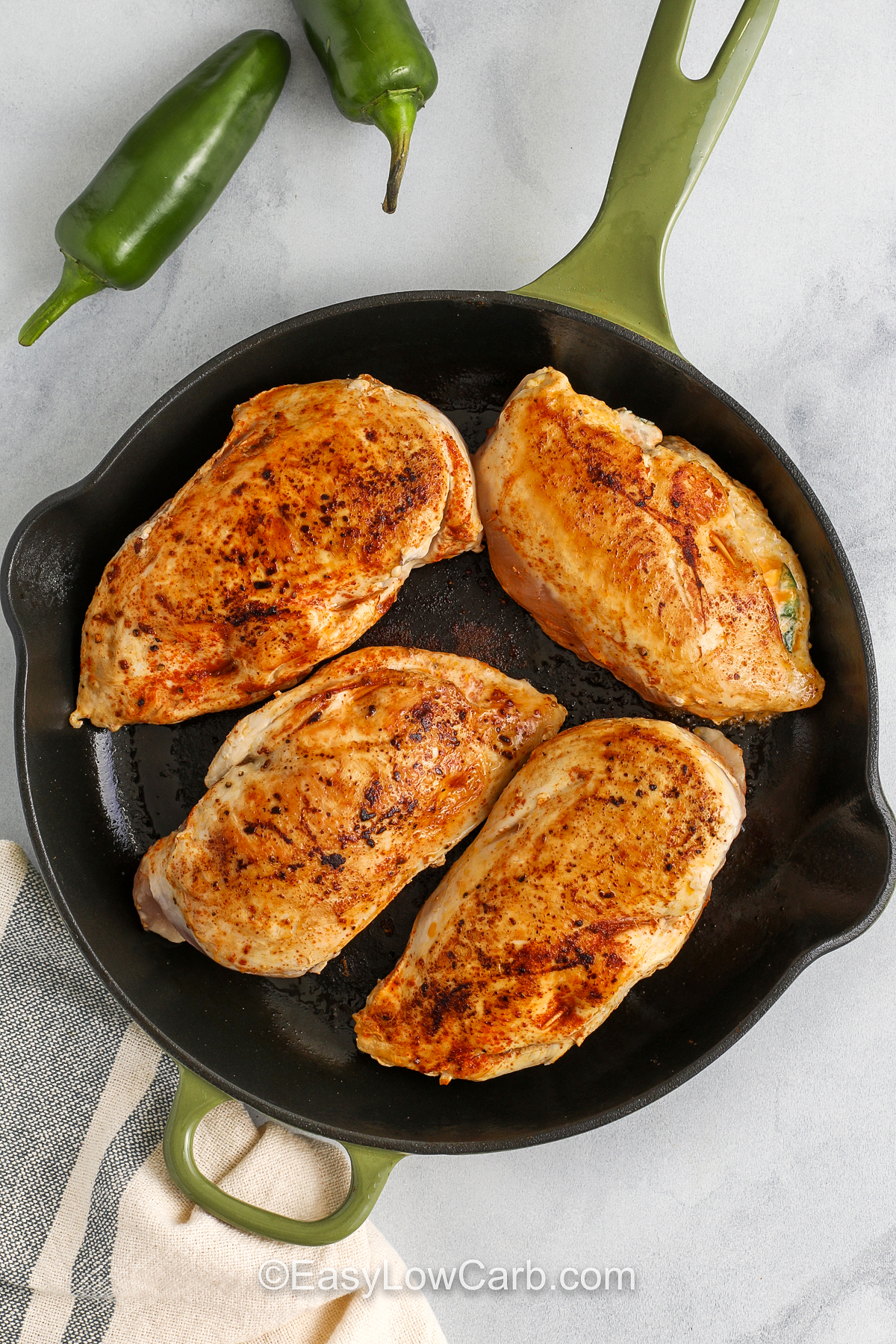 jalapeno popper chicken breasts being cooked in a frying pan