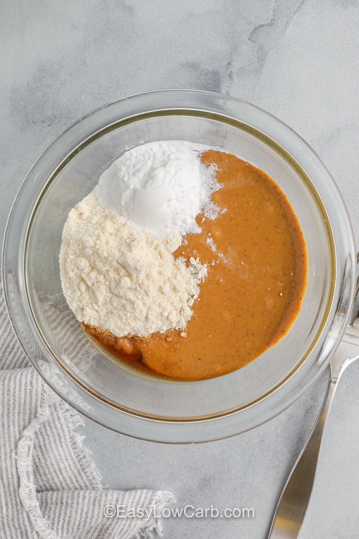 Ingredients to make peanut butter balls combined in a bowl