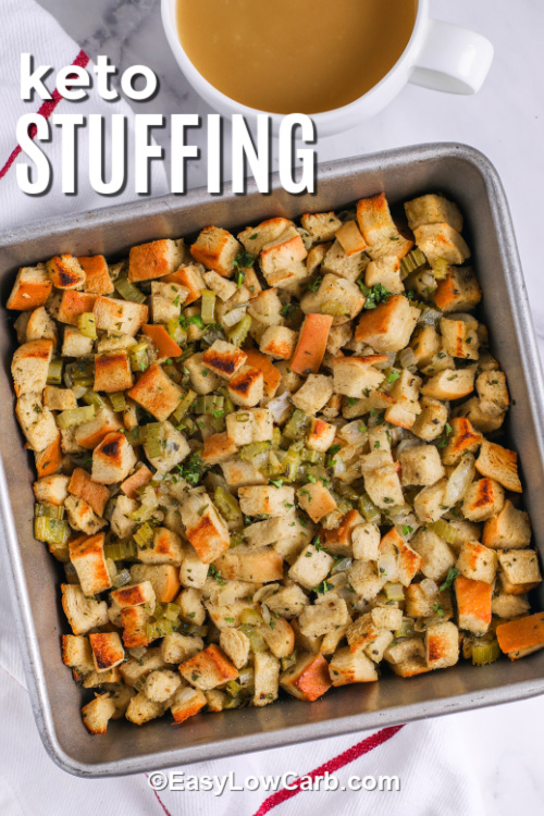 Keto stuffing is a comforting, flavorful recipe perfect for any holiday table. Golden toasted keto bread cubes, sautéed onions, crisp celery, fresh herbs, and poultry seasoning combine with savory chicken broth. Baked until golden and slightly crisp, this low carb side is easy to make and brings the warmth and nostalgia of Thanksgiving stuffing to every meal. #easylowcarb a pan with prepared keto stuffing with a title