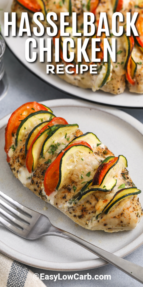 Hasselback chicken is a flavorful, low-carb dinner that's as stunning as it is simple to make. Sliced chicken breasts are filled with a creamy cheese mixture, fresh zucchini, and juicy tomatoes. Baked to perfection and topped with golden parmesan, this dish is both elegant and satisfying. It’s perfect for keto-friendly weeknight meals and a great way to enjoy your veggies with every bite. #easylowcarb Hasselback chicken on a plate with a fork with a title