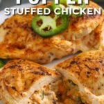 Jalapeno popper chicken on a plate cut in half with the filling melting out with a title