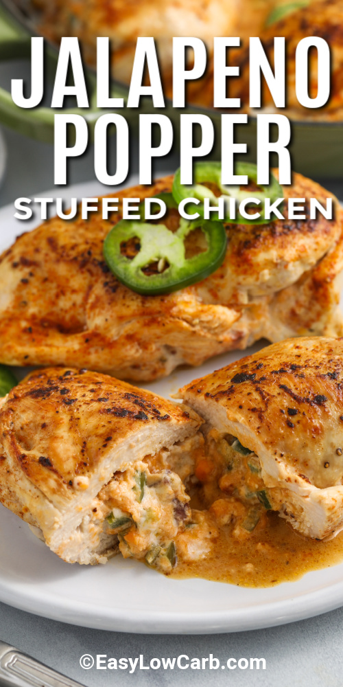 Jalapeno popper chicken on a plate cut in half with the filling melting out with a title