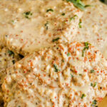 Turkey Breast cutlets on a serving tray topped with dijon sauce with a title