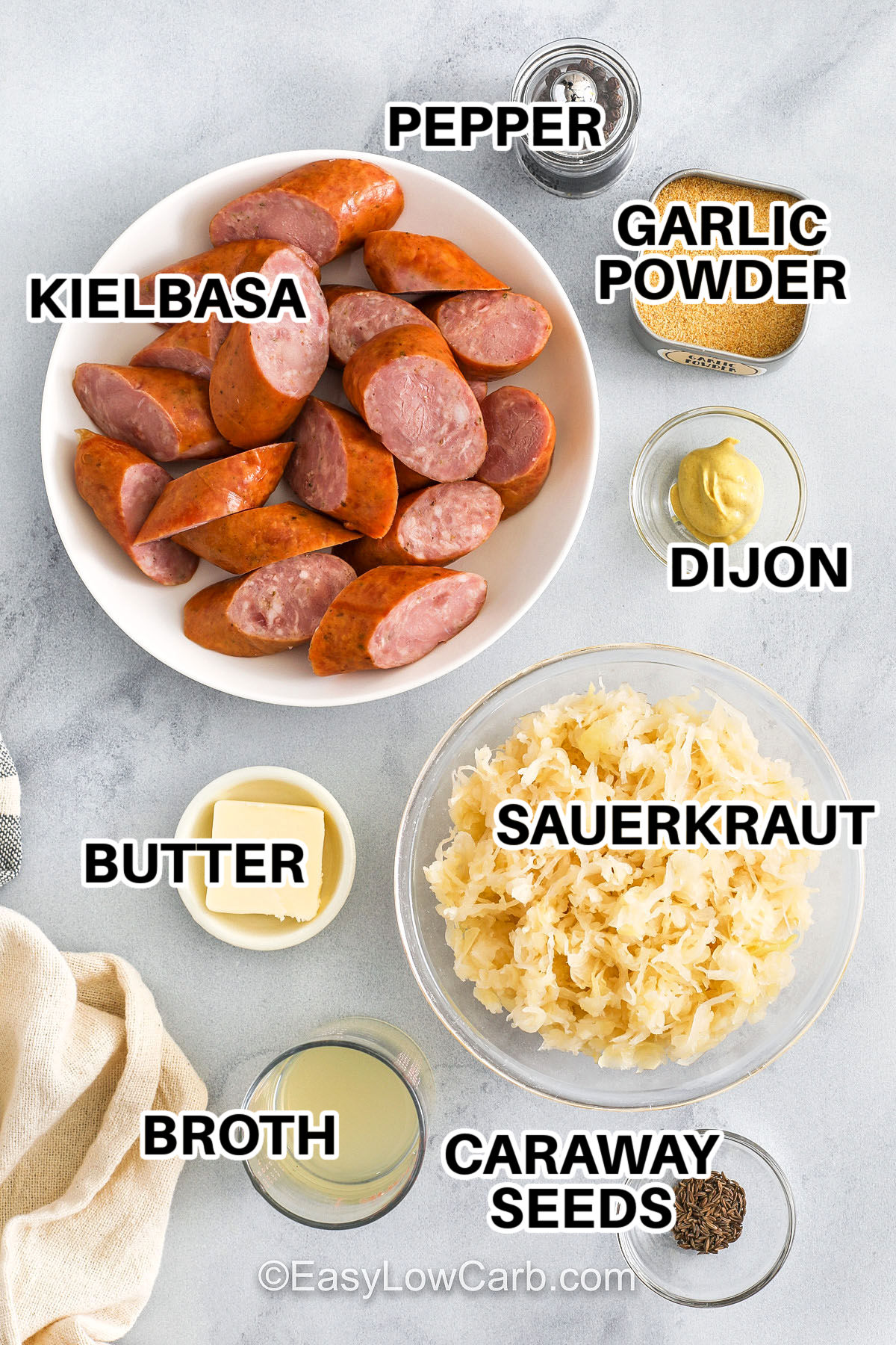 Kielbasa and sauerkraut comes together in a warm skillet with savory sausage that browns nicely and cabbage that softens into a hearty mix perfect for dinner. This easy recipe uses broth and mustard to add comfort and cooks well in one pot for a weeknight or a holiday. Serve it plain or with potatoes to enjoy the best flavor and texture in every bite, and make the table feel complete with simple home-cooked goodness. #easylowcarb kielbasa , pepper , garlic powder , dijon , sauerkraut , butter , broth , caraway seeds with labels to make Kielbasa and Sauerkraut
