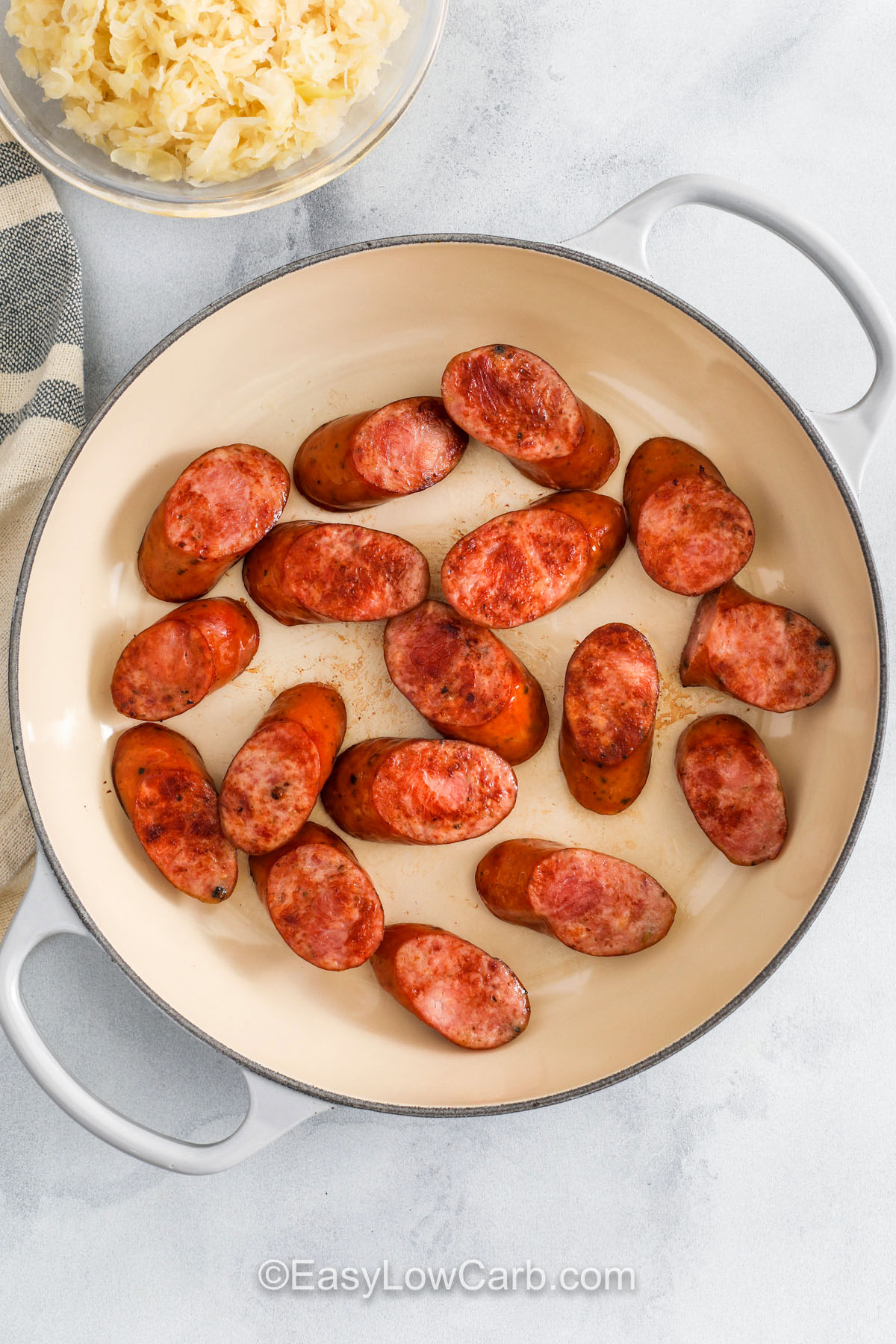 Kielbasa and sauerkraut recipe lovers will enjoy this hearty mix of sausage, soft sauerkraut, and a savory blend of broth and mustard that comes together in a warm skillet. This easy one-pot dish makes a great dinner for a weeknight or a holiday because the flavors stay simple and comforting. Serve it with potatoes or enjoy it on its own, and let the best textures and tastes fill the plate with classic goodness. #easylowcarb cooked kielbasa to make Kielbasa and Sauerkraut