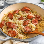horizontal pan full of Kielbasa and Sauerkraut