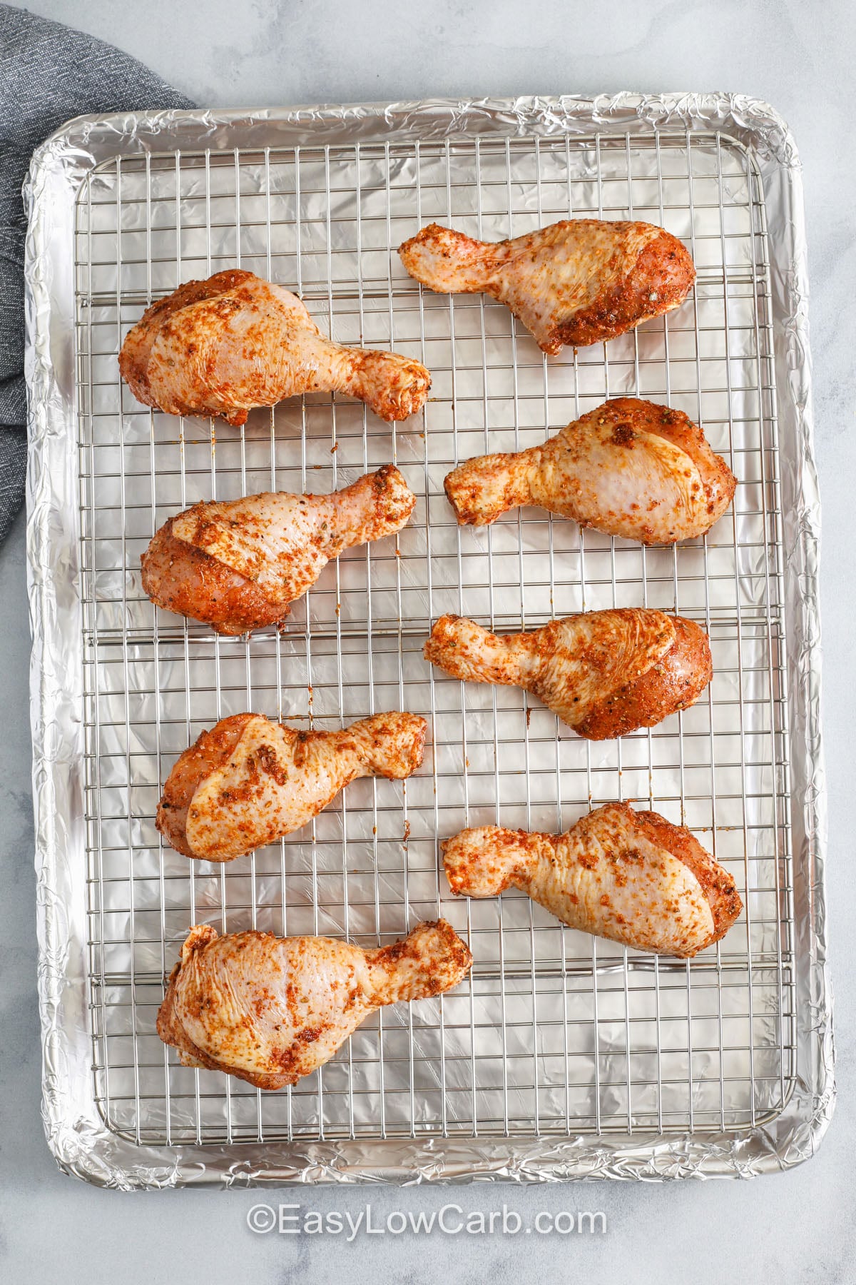 Make easy oven-baked chicken drumsticks that stay tender inside and crisp outside with a simple low-carb seasoning blend. The smoky paprika and garlic add big flavor while the high-heat baking method keeps the skin perfectly crisp. This recipe works well for busy families, low-carb meal prep, or pairing with your favorite keto vegetables. It’s dependable, budget-friendly, and always satisfying. #easylowcarb chicken drumsticks on a sheet pan to make Oven Baked Chicken Drumsticks