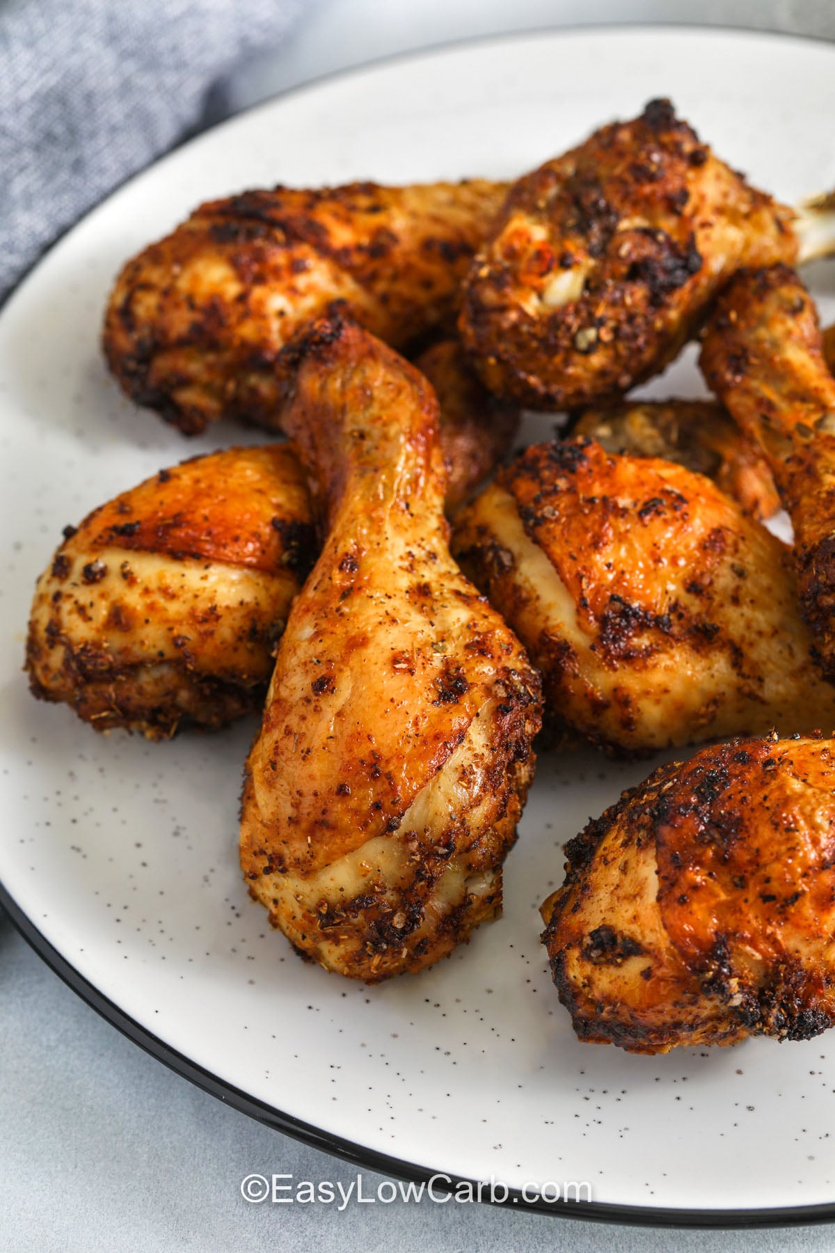 Enjoy low-carb oven-baked chicken drumsticks seasoned with smoked paprika and garlic for a flavorful, satisfying dinner. The seasoning mixture helps create a crisp outer layer while the chicken stays tender inside. This recipe is easy to customize with your favorite keto-friendly spices and works well for weekly meal prep. Pair it with simple sides like steamed broccoli or cauliflower rice for a complete low-carb plate. #easylowcarb close up of Oven Baked Chicken Drumsticks