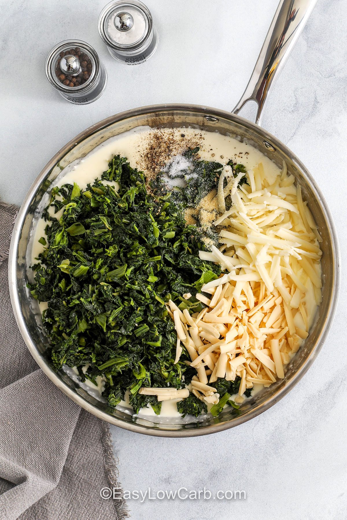 Spinach casserole creates a simple and comforting side with creamed spinach and a blend of cheese that bakes into tender layers. The warm and rich taste feels old-fashioned and fits well on any dinner table. It works for holiday meals or potlucks and brings a cheesy flavor that makes veggies taste extra good. This recipe offers a creamy texture and cozy flavor that everyone at the table can enjoy. #easylowcarb adding spinach and cheese to make Spinach Casserole