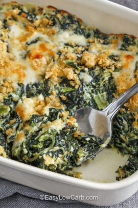Spinach Casserole in a casserole dish with a spoon