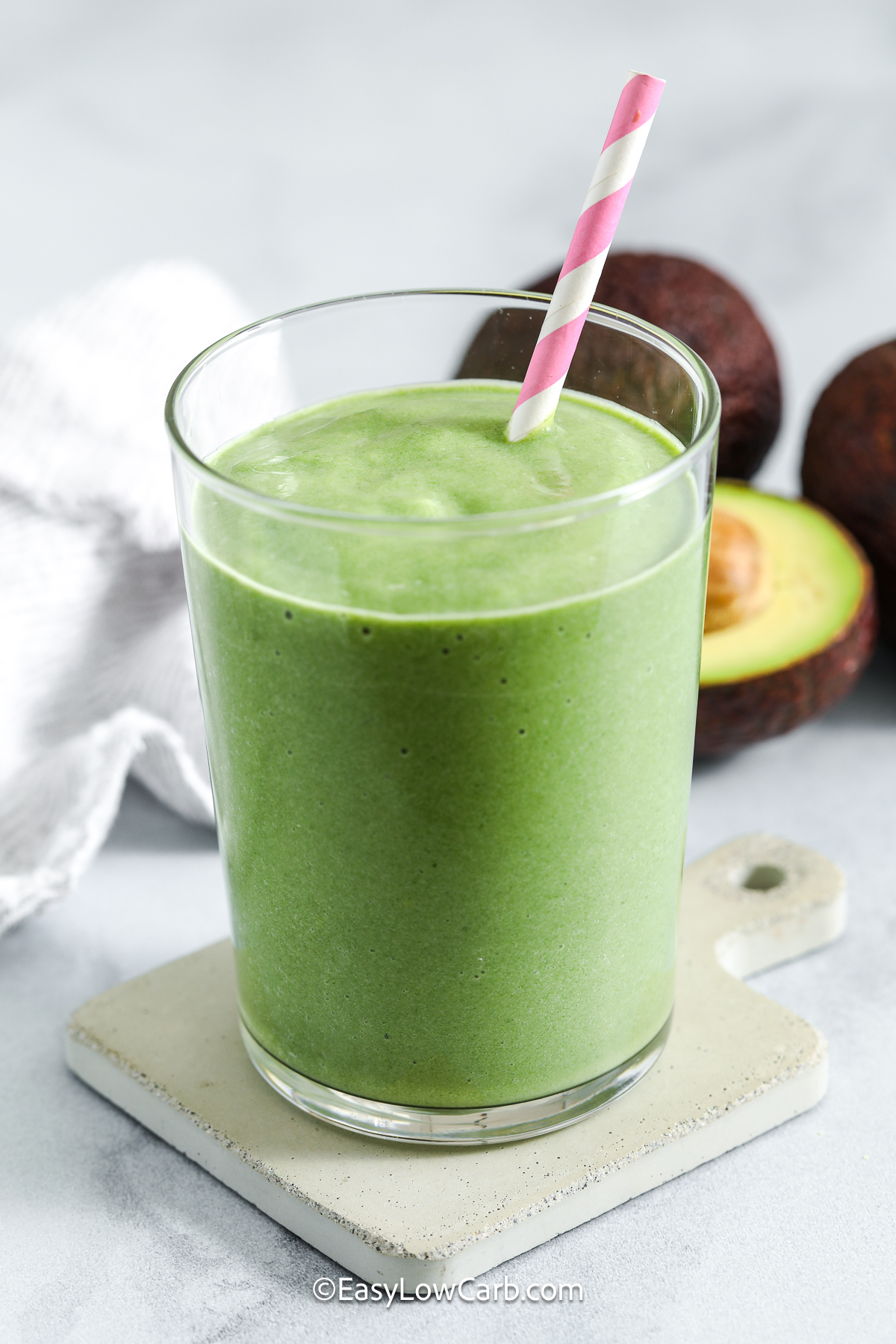 Make a cool and velvety avocado smoothie using spinach, almond milk, and vanilla protein. This is an easy morning or afternoon boost. The avocado creates a creamy consistency that pairs well with the subtle sweetness of the protein powder. With just a handful of ingredients, this smoothie blends quickly and tastes refreshing and light. It is a simple, nutrient-packed option for anyone looking for a satisfying, low carb drink. #easylowcarb avocado smoothie in a glass