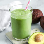 avocado smoothie surrounded by avocados