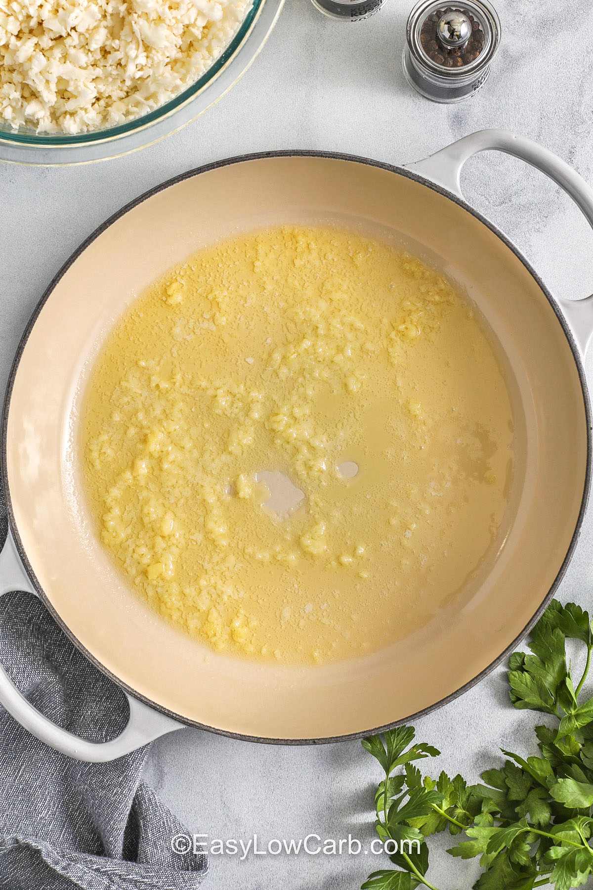 Try this Cauliflower Rice Recipe for a quick, healthy side that delivers tender texture and light garlic flavor. It’s made from fresh cauliflower and cooks in minutes, making it perfect for bowls, curries, and low-carb dinners. Keep a batch on hand for meal prep or freeze raw riced cauliflower for future meals. #easylowcarb melted butter and garlic in a pan to make Cauliflower Rice Recipe