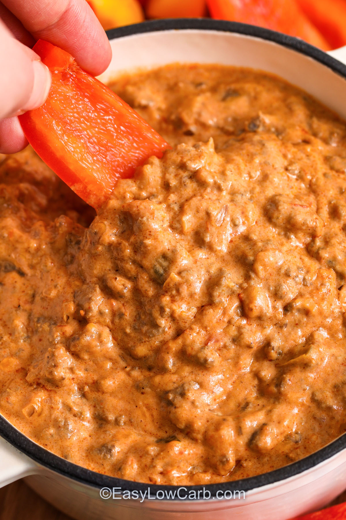 This cream cheese salsa dip style Chili Cheese Dip is a crowd-pleaser that fits a low carb plan. The key is to first drain the beef well, then melt the cream cheese slowly so that the dip stays creamy, not oily. Add shredded cheddar at the end for the smoothest melt. Serve with cheese crisps or low carb chips, and reheat leftovers gently on the stove with a splash of liquid for the best texture. #easylowcarb dipping a pepper in Chili Cheese Dip