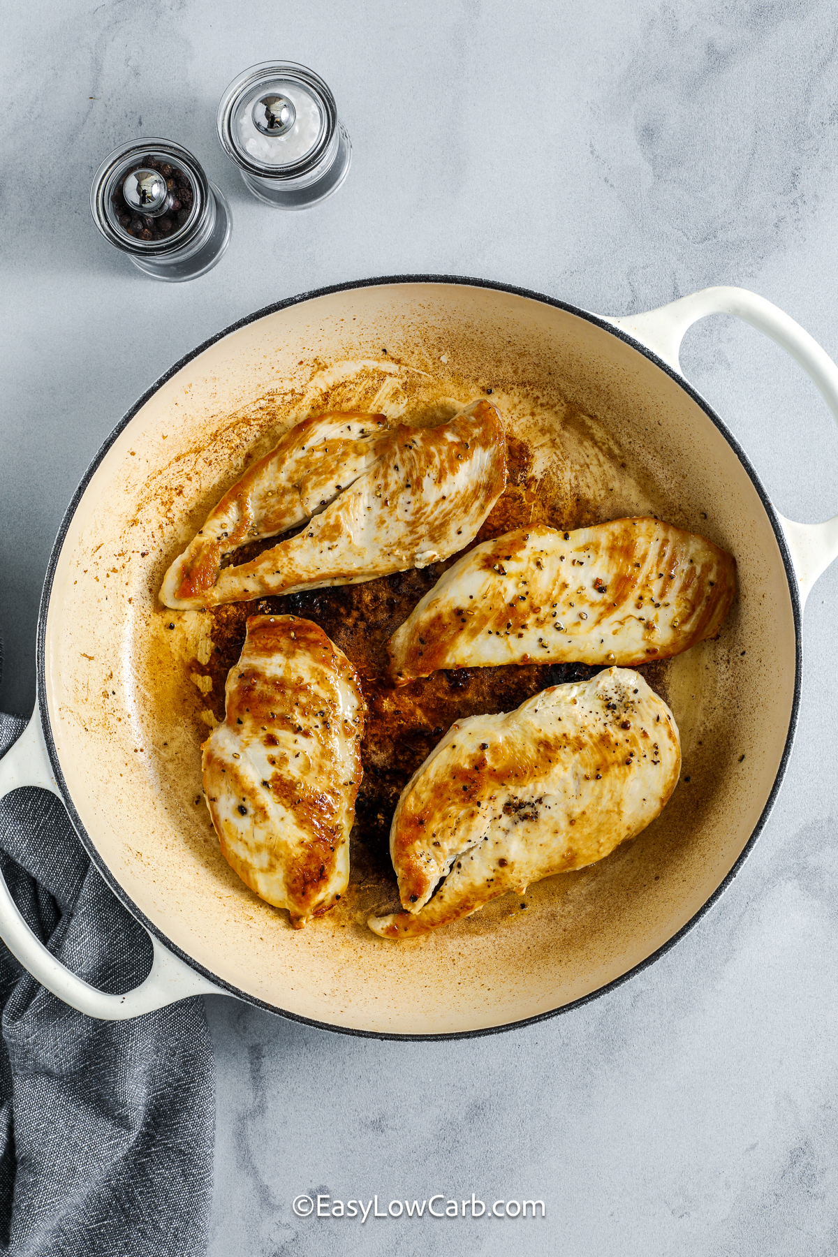 This low carb creamy lemon chicken delivers bold flavor in a straightforward skillet recipe. The chicken is cooked until golden, then a quick pan sauce is built with butter, garlic, chicken broth, heavy cream, lemon zest, and lemon juice. The result is a smooth, tangy sauce that coats each piece of chicken and any vegetables you serve alongside it. Ideal for weeknights, it uses staple ingredients and turns simple chicken into a satisfying meal. #easylowcarb cooked chicken in a pan