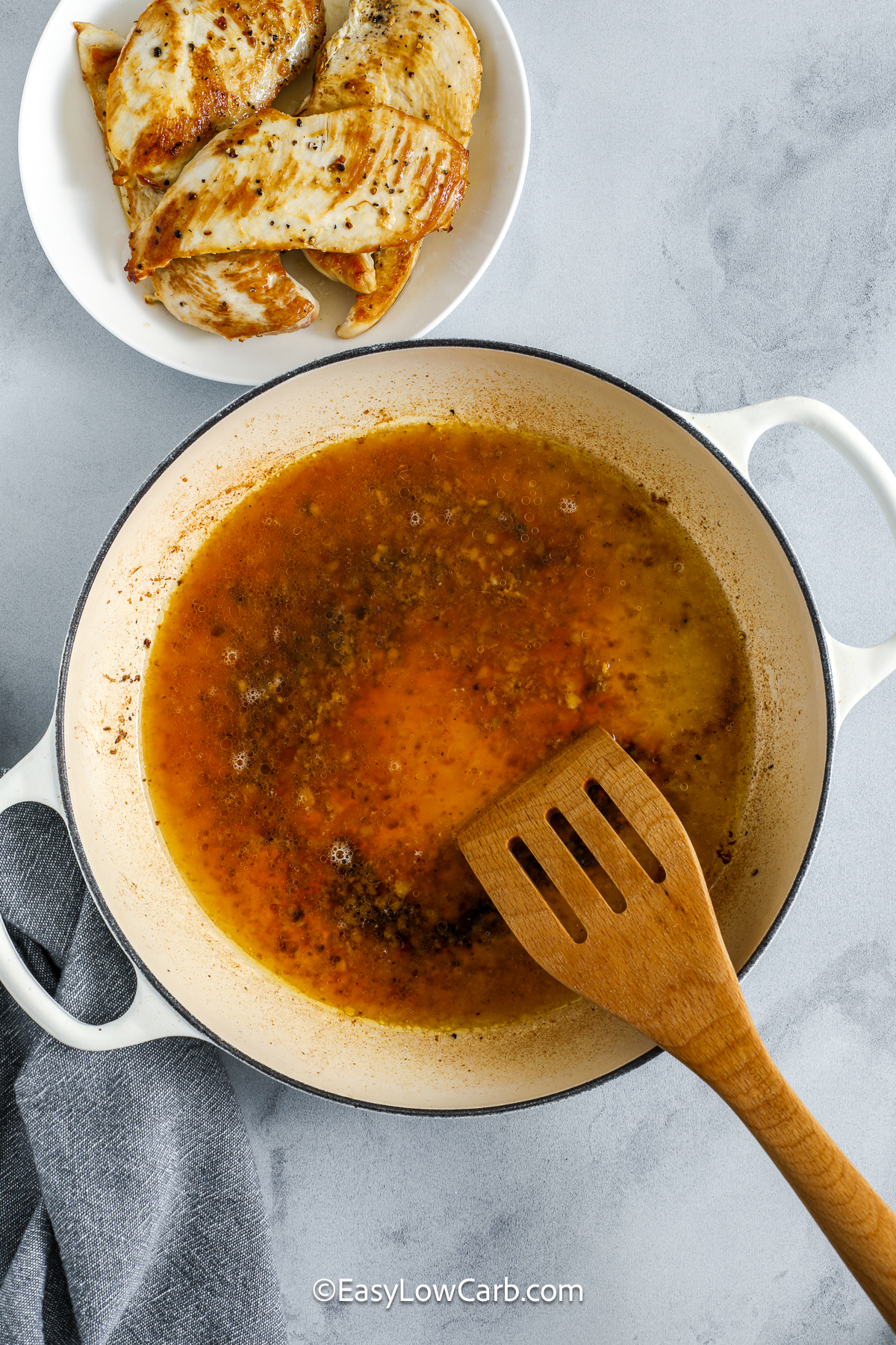 Make this creamy lemon chicken for a family friendly dinner. The base is simple, using chicken, broth, cream, garlic, and lemon, so you can add baby spinach, extra herbs, or a sprinkle of Parmesan to suit your taste. The low carb sauce pairs just as well with zoodles and cauliflower rice as it does with traditional sides for anyone not watching carbs. It is versatile, comforting, and very easy. #easylowcarb sauce ingredients in a pan