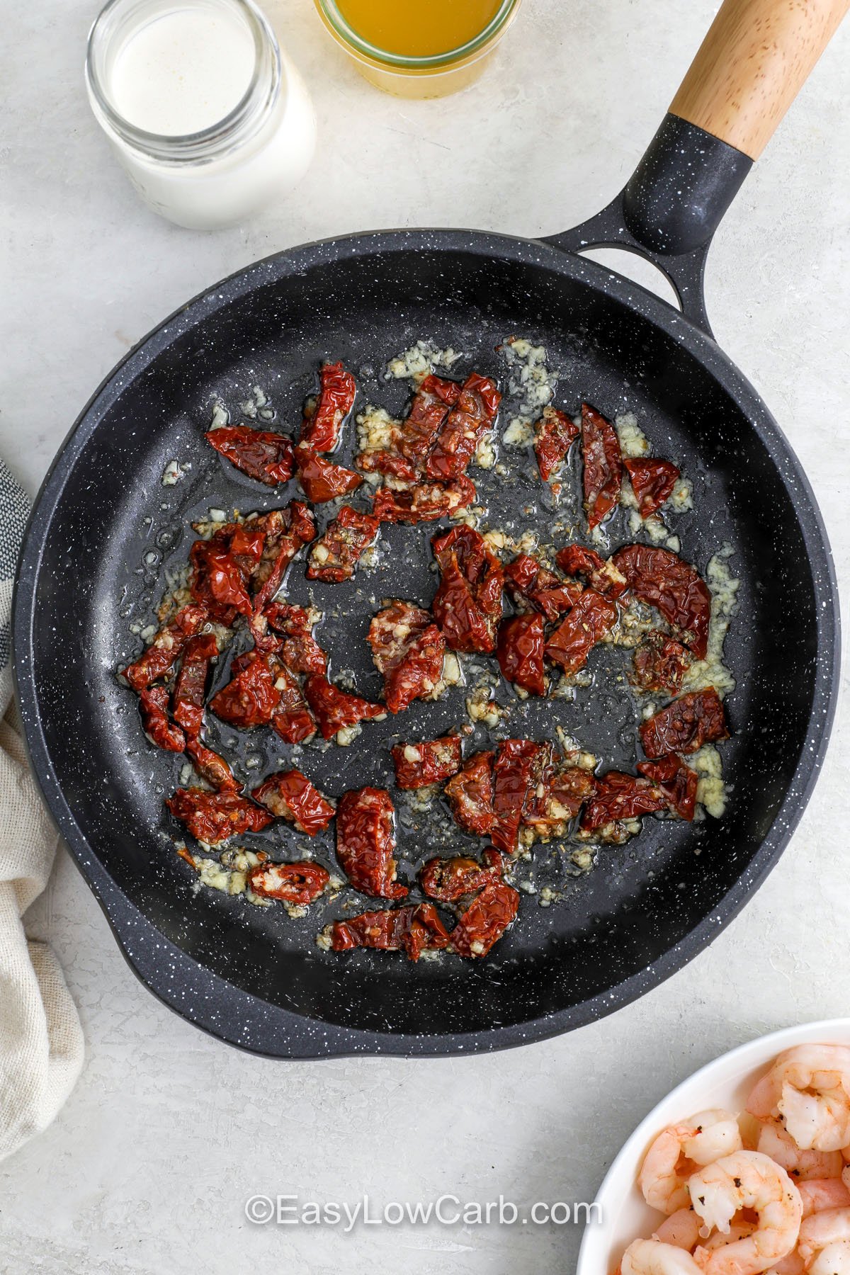 This creamy Tuscan shrimp recipe is all about texture and balance. Juicy shrimp and tender spinach are coated in a creamy Parmesan sauce with garlic and Italian seasoning, while chopped sun-dried tomatoes add tang and richness. It is a quick one pan dinner that works well for low carb eating when served over zucchini noodles or cauliflower rice. Satisfying, simple, and weeknight friendly. #easylowcarb cooking sun dried tomatoes with garlic to make Creamy Tuscan Shrimp