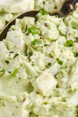 Bowl of avocado egg salad with a spoon in it