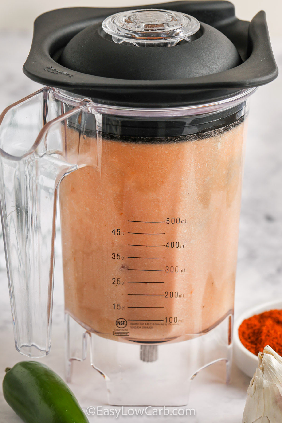 This low carb chili brings together beef, turkey, diced tomatoes, and cauliflower for a flavorful and satisfying low-carb meal. Blending part of the cauliflower creates a thick, cozy texture without flour or beans, while peppers and garlic build layers of flavor. It’s a one-pot stovetop recipe that’s ideal for easy dinners, weekly meal prep, or freezing for later. Serve it hot with your favorite toppings for a comforting bowl. #easylowcarb blender full of blended ingredients to make Low Carb Chili