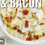 fried cabbage and bacon in a white bowl and writing