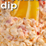 dipping a pepper in Sausage Cheese Dip with writing