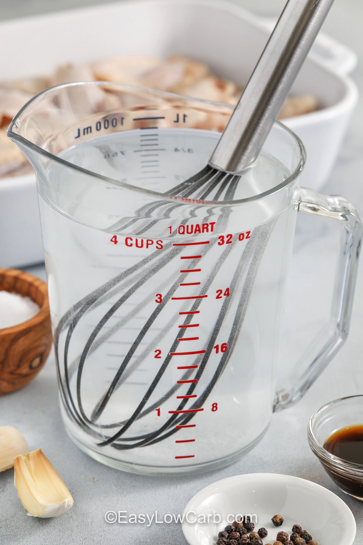 This wet chicken wing brine recipe is built for busy cooks who still want great results. The brine is made with pantry staples like kosher salt, Worcestershire sauce, peppercorns, and garlic. After a short chill in the fridge, draining and drying the wings is the key to crispiness. Bake or air fry, then add your favorite sauce without watering it down. #easylowcarb whisking salt and water to make Chicken Wing Brine