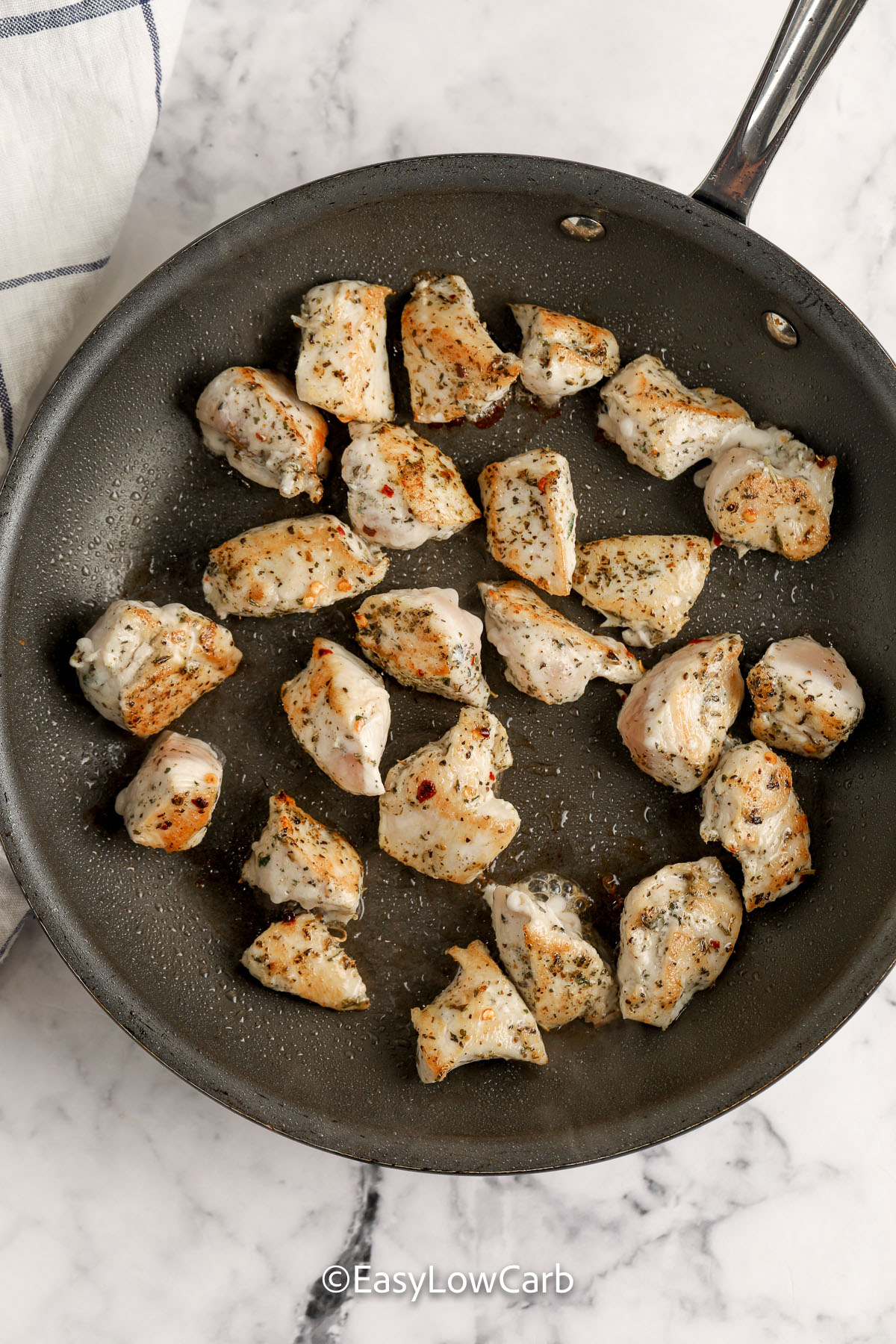This creamy Tuscan chicken skillet with cauliflower is a simple one-pan dinner for busy nights. Seasoned chicken pieces get a quick sear, then simmer in a heavy cream sauce with Parmesan, sun-dried tomatoes, and spinach. Cooking the cauliflower first keeps the skillet from turning watery and helps it soak up flavor. Reheat gently on low heat with a splash of broth or cream for the best texture. #easylowcarb browned chicken in a skillet