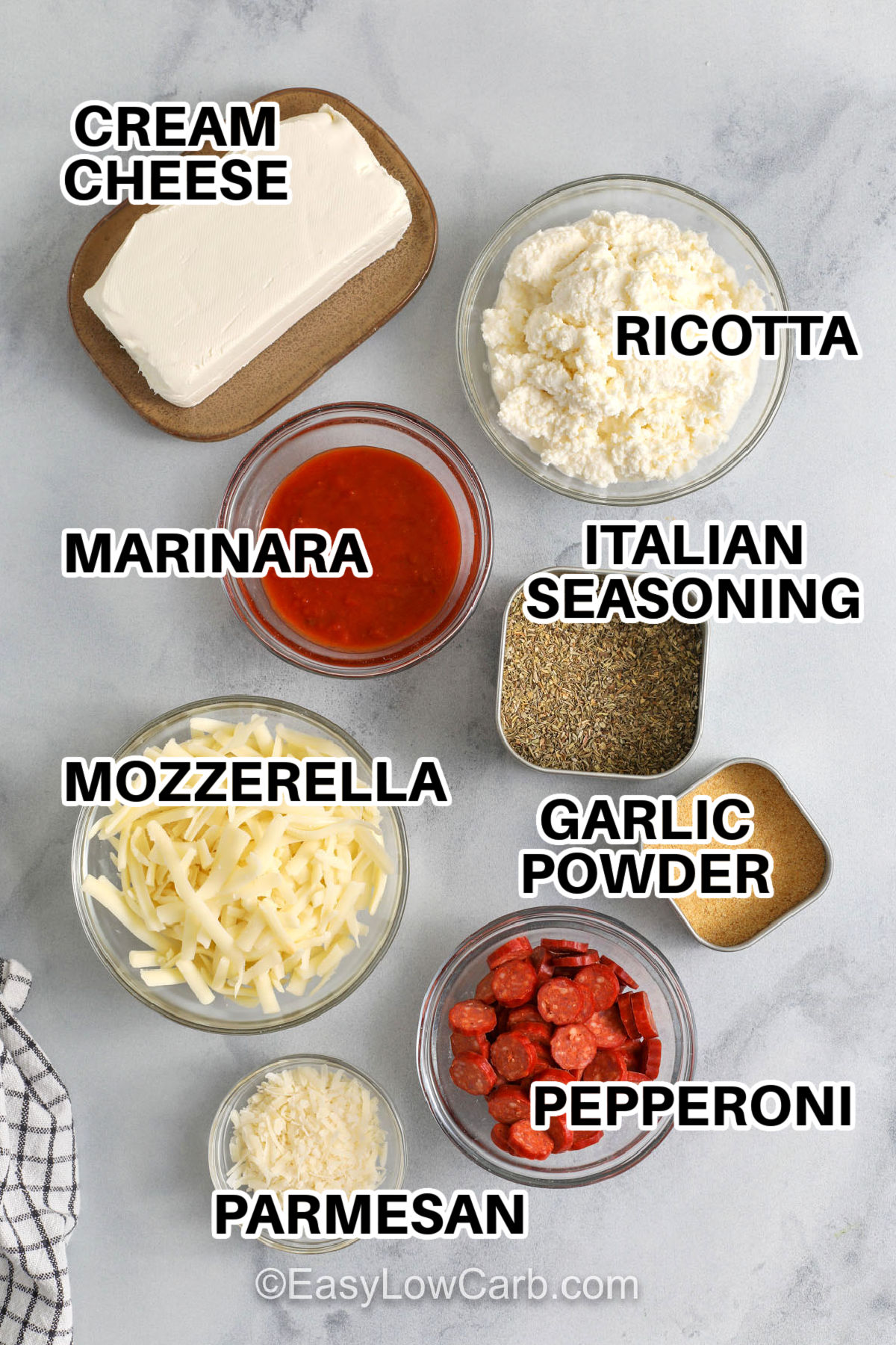 This pepperoni dip bakes into a hot, bubbly appetizer with all the flavors of pizza night. A whipped cream cheese and ricotta base keeps it smooth and scoopable, while low sugar marinara adds tang and mozzarella melts into a stretchy topping. Finish with pepperoni on top for crisp edges. Serve with bell peppers, cucumbers, or low carb crackers for an easy party dip. #easylowcarb cream cheese , ricotta cheese , mozzerella cheese , parmesan cheese , marinara , italian seasoning , garlic powder , pepperoni with labels to make Pepperoni Dip