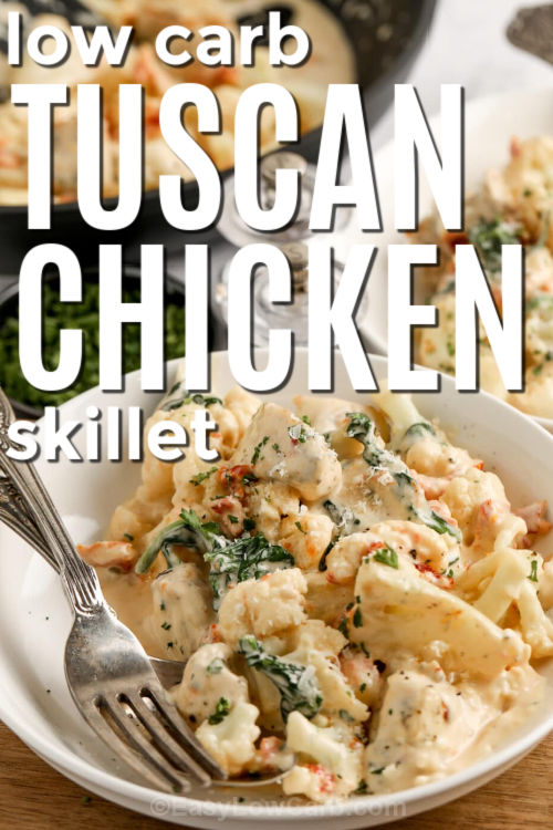 Creamy Tuscan chicken skillet is the low carb dinner that feels special without extra work. Chicken is browned, then finished in a creamy garlic parmesan sauce with oil-packed sun-dried tomatoes and spinach. Cauliflower simmers briefly in broth first, then finishes in the skillet so it stays tender-crisp and the sauce stays thick. Serve as-is or over cauliflower rice for a cozy keto meal. #easylowcarb tuscan chicken in a bowl with a fork and writing
