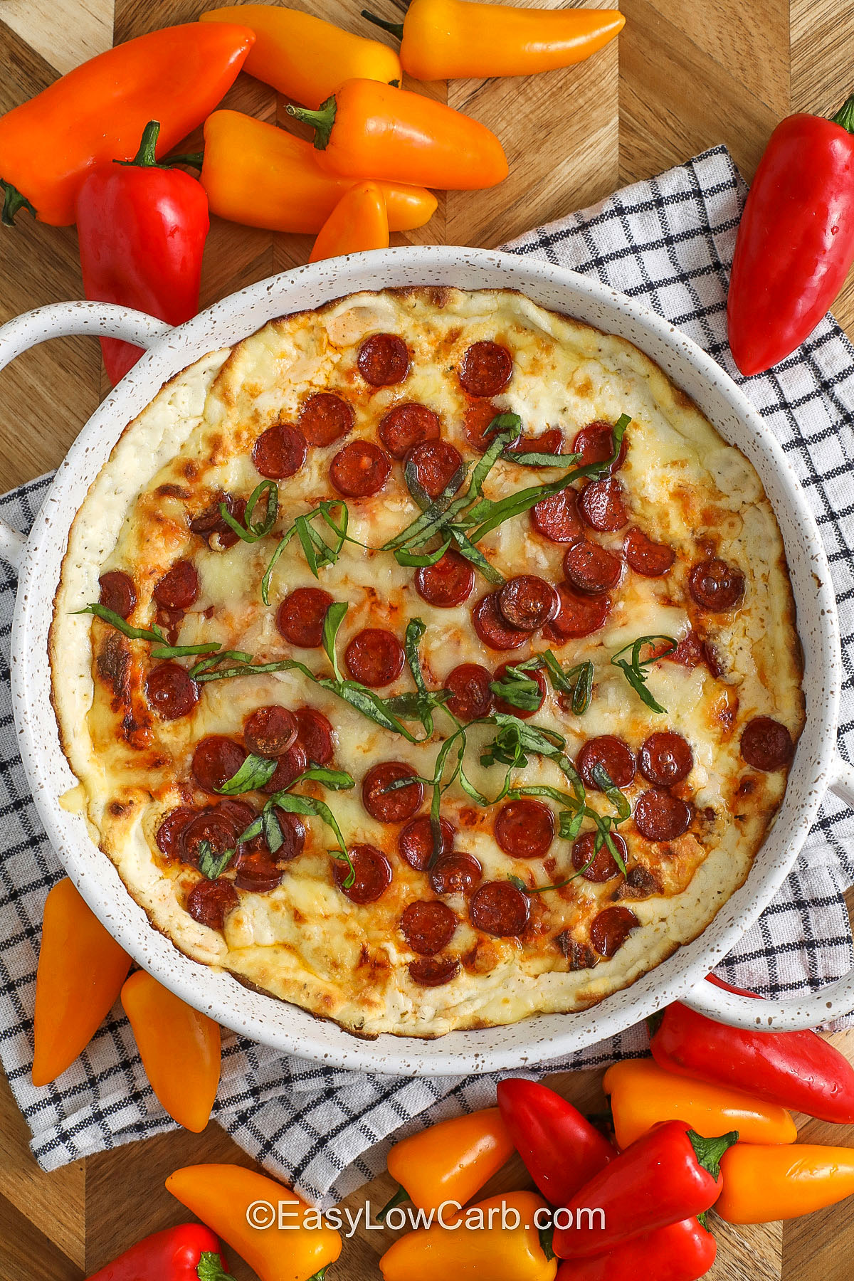 Make this pepperoni dip when you want pizza flavor without the fuss. The creamy base combines ricotta, cream cheese, Italian seasoning, and garlic powder, then bakes under marinara, mozzarella, and parmesan until melted and bubbly. Mini pepperoni spreads out perfectly for bite-sized flavor in every scoop. It is satisfying, protein-forward, and great with crunchy veggie dippers. #easylowcarb top view of Pepperoni Dip in bowl