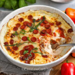 plated Pepperoni Dip with red and yellow peppers around it