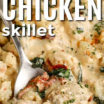 creamy tuscan skillet in a pan with a spoon and writing