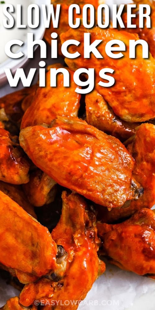 These slow cooker chicken wings are naturally low carb and skip the fryer. Cook the wings in a buttery hot sauce blend, then broil to brown the skin and help the sauce set. Patting wings dry and broiling in a single layer makes a big difference. Pair with low carb coleslaw for a crisp, fresh side that balances the heat. #easylowcarb close up of Crockpot Chicken Wings with writing