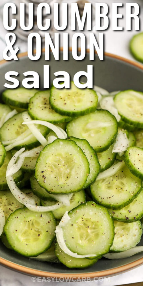 Make an easy cucumber onion salad that delivers big flavor with minimal ingredients. English cucumbers stay crisp, while sliced onion softens slightly in a simple white wine vinegar vinaigrette with oil, salt, and pepper. The light sweetness balances the tang without feeling heavy, making this vinegar cucumber salad a refreshing low carb side. Chill it for at least an hour so the flavors blend, then toss and serve cold. #easylowcarb Cucumber and Onion Salad in a bowl with writing