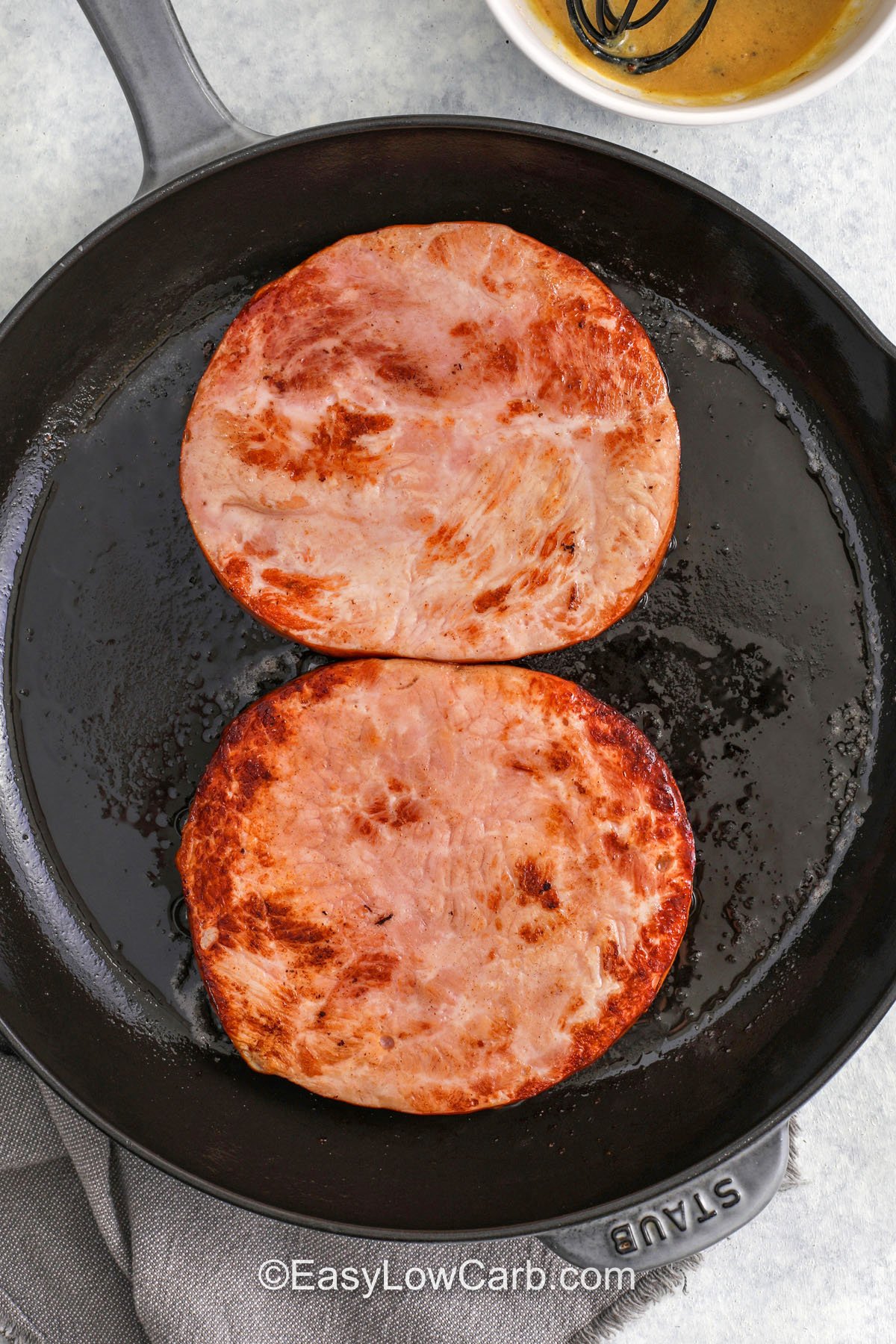 This low carb ham steak recipe uses a quick sear and a fast pan glaze to keep the ham tender. Dijon mustard adds depth, butter makes the sauce rich, and apple cider vinegar brightens every bite. A brown sugar style sweetener gives the classic glazed ham vibe without extra carbs. Serve it with cauliflower rice or sautéed green beans for a balanced plate, and freeze extra slices for future meals. #easylowcarb cooking slices of ham to make Ham Steak