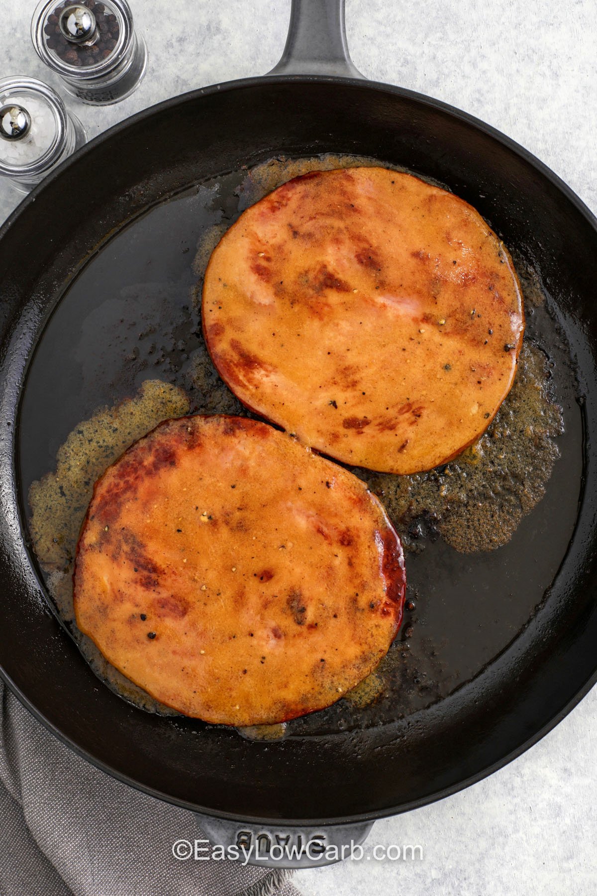 Make this ham steak recipe when you want the flavor of glazed ham without roasting a whole ham. Sear the ham in butter, then spread on a Dijon glaze with apple cider vinegar and low carb brown sugar sweetener. Cover briefly so the sauce melts and turns glossy, then spoon it over sliced ham for a restaurant worthy finish. It is a simple low carb dinner that feels special with very little work. #easylowcarb adding glaze to ham to make Ham Steak