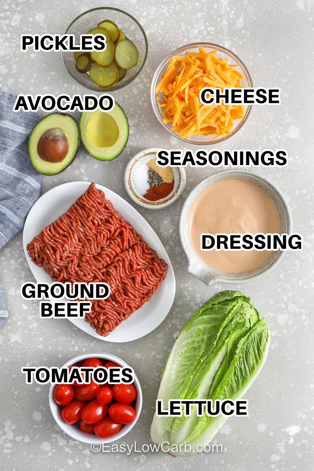 This low carb cheeseburger bowl is the easiest way to satisfy a cheeseburger craving without a bun. Cook ground beef or chicken with smoked paprika and garlic powder, then build bowls with lettuce, cheddar, pickles, and tomatoes. The creamy burger sauce dressing is made with mayo, Greek yogurt, sugar-free ketchup, mustard, and pickle juice for a tangy finish. Great for weeknight dinners and meal prep. #easylowcarb pickles , avocado , cheese , ground beef , tomatoes , lettuce , dressing , seasonings with labels to make Cheeseburger Bowl