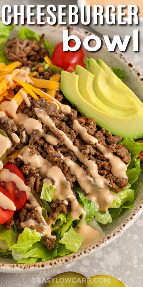 Make this low carb cheeseburger bowl when you want comfort food that still feels fresh. Brown ground beef or ground chicken, season with smoked paprika and garlic powder, then pile it into bowls with romaine or iceberg. Top with cheddar, tomatoes, pickles, and avocado, then drizzle with a creamy special sauce dressing. It is perfect for quick weeknights and easy to customize for picky eaters. #easylowcarb close up of Cheeseburger Bowl with avocado and a title