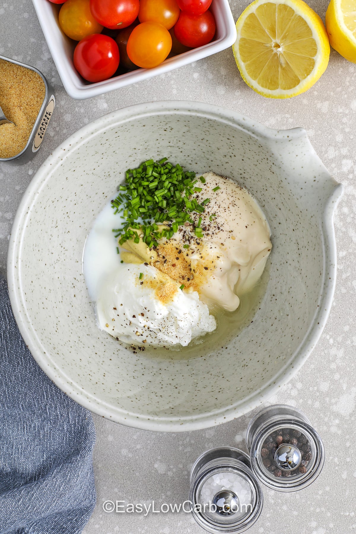 This keto BLT salad is a simple dinner salad that tastes like your favorite sandwich, minus the carbs. Crisp lettuce, cherry tomatoes, bacon, cheddar, and avocado make it satisfying without croutons. The creamy dressing is made with mayo, Greek yogurt, lemon, Dijon, and chives, then thinned with milk to your preferred consistency. Great for quick lunches and easy weeknights. #easylowcarb BLT dressing ingredients in a bowl