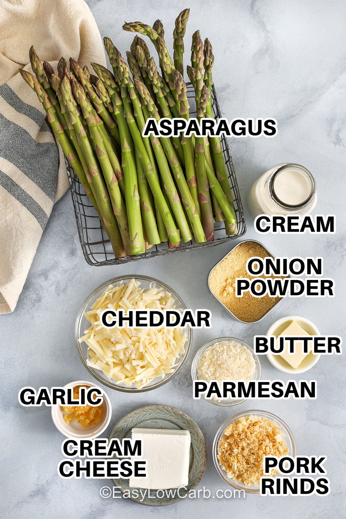 This asparagus casserole is an easy keto side dish that checks every box: creamy sauce, bold cheese flavor, and a crunchy topping. Heavy cream and cream cheese create a smooth texture, while sharp cheddar or gruyere adds richness. Parmesan and crushed pork rinds form a golden crust that makes each bite satisfying. It is low carb, gluten free, and perfect for holidays or potlucks. #easylowcarb asparagus , cream , onion powder , butter , pork rinds , cream cheese , garlic , parmesan and cheddar with labels to make Asparagus Casserole