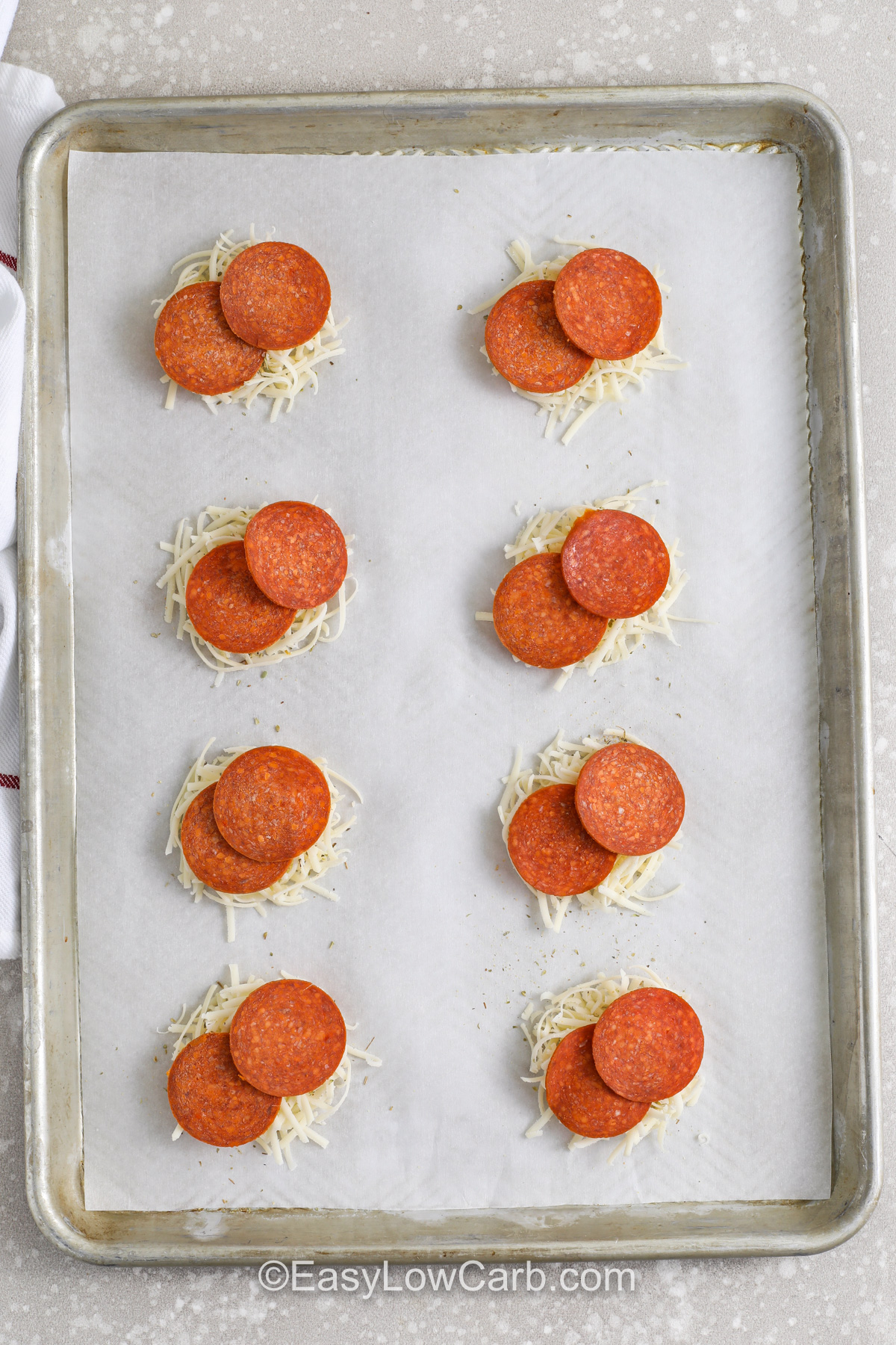 Pizza chips are baked mozzarella cheese crisps topped with pepperoni and Italian herbs, and they are perfect for dipping. Use finely shredded mozzarella so the chips melt evenly, then bake until the edges are deeply golden for the best crunch. Cooling time is key because it sets the cheese into a crisp texture. Serve with low carb marinara sauce, ranch, or a creamy dip for an easy keto-friendly appetizer. #easylowcarb adding pepperoni to cheese to make Pizza Chips