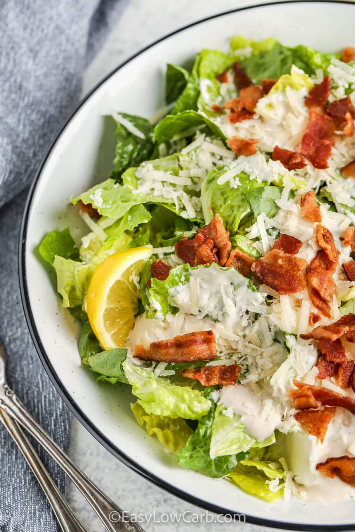 Keto Caesar salad is an easy, low-carb salad packed with fresh romaine, bacon, and a creamy homemade Caesar dressing. This keto-friendly recipe is perfect for anyone wanting a simple salad that still feels hearty and flavorful. The dressing blends Parmesan, garlic, and lemon for a smooth and tangy taste. It is great for meal prep or serving alongside grilled meats. #easylowcarb Low Carb Caesar Salad with crispy bacon