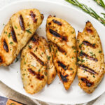 Grilled chicken breasts on a serving plate