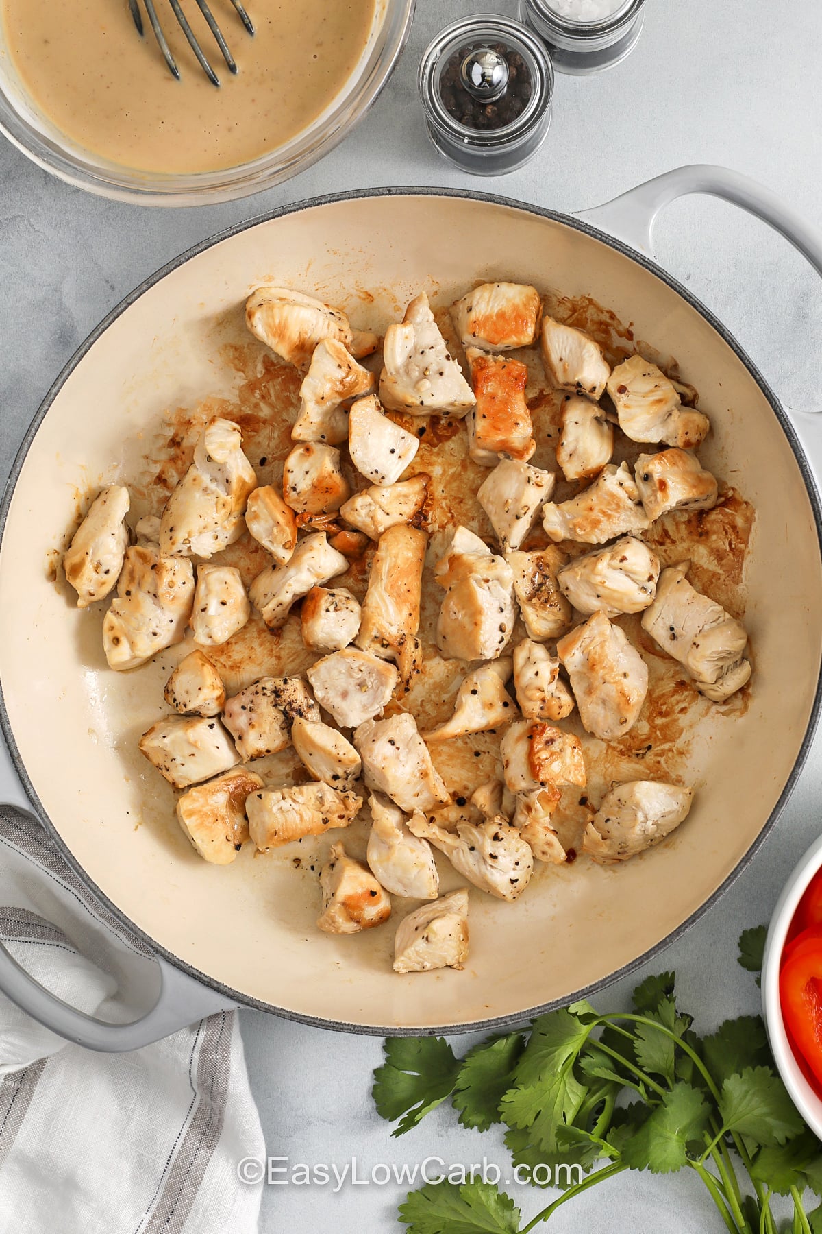 Creamy peanut chicken is a flavorful way to change up your usual chicken dinner without adding extra work. The combination of peanut butter and coconut milk makes a rich sauce that clings to every piece of chicken, while lime juice and chili flakes keep it balanced. This recipe is easy to customize with different vegetables and works well for meal prep, leftovers, or a simple low carb dinner at home. #easylowcarb cooked chicken in pan to make Peanut Chicken