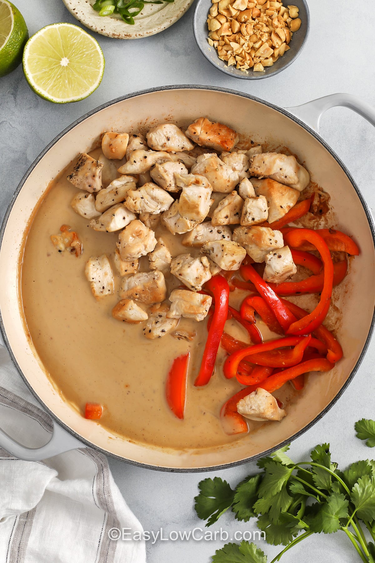 This peanut chicken recipe keeps things simple with everyday ingredients and one skillet. Bite-sized chicken breast browns quickly, the red pepper softens in just a few minutes, and the peanut sauce comes together with coconut milk, garlic, ginger, and lime for a smooth finish. It is the kind of dinner that tastes like takeout but fits real life, especially when you need a quick meal that reheats well the next day. #easylowcarb adding chicken and pepper to peanut sauce to make Peanut Chicken