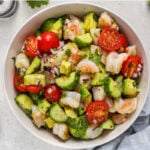 Shrimp Avocado Salad prepared in a bowl with lime wedges on the side