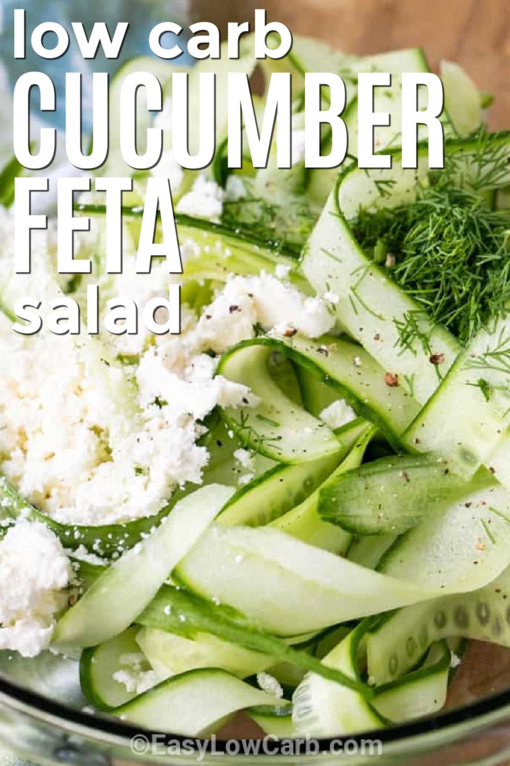 Cucumber feta salad is the fresh side dish your summer table has been waiting for. Crisp cucumber ribbons are tossed in a bright lemon dill dressing and finished with crumbled feta for plenty of fresh flavor. It pairs beautifully with grilled chicken, burgers, seafood, or sandwiches, making it an easy choice for cookouts and family dinners. Add this simple cucumber salad to your menu and enjoy every bite. #theshortcutkitchen low carb Cucumber Feta Salad with writing