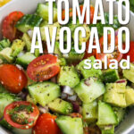 bowl of fresh Cucumber Tomato Avocado Salad with writing